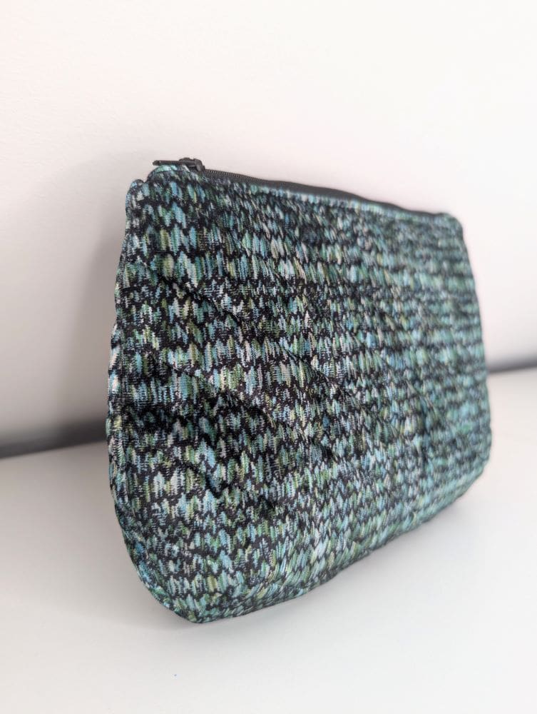 Handmade zipper pouch featuring a unique green and black textured fabric pattern