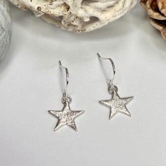 Handmade silver dangly star earrings with glitter effect