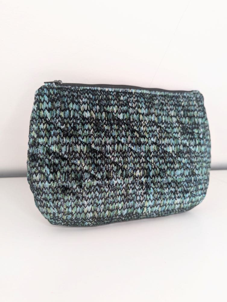 Stylish woven makeup bag with a compact design, perfect for everyday use