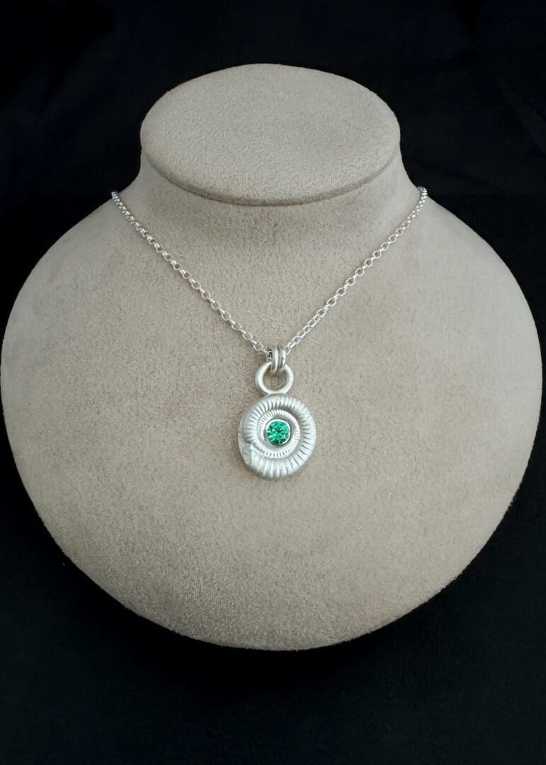 My Jewellery Garden Handmade Recycled Sterling Silver Ammonite Pendants with Green or Teal Cubic Zirconia