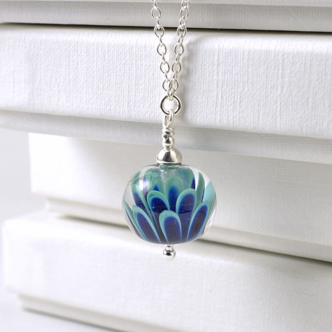 Small lampwork glass flower necklace in teal