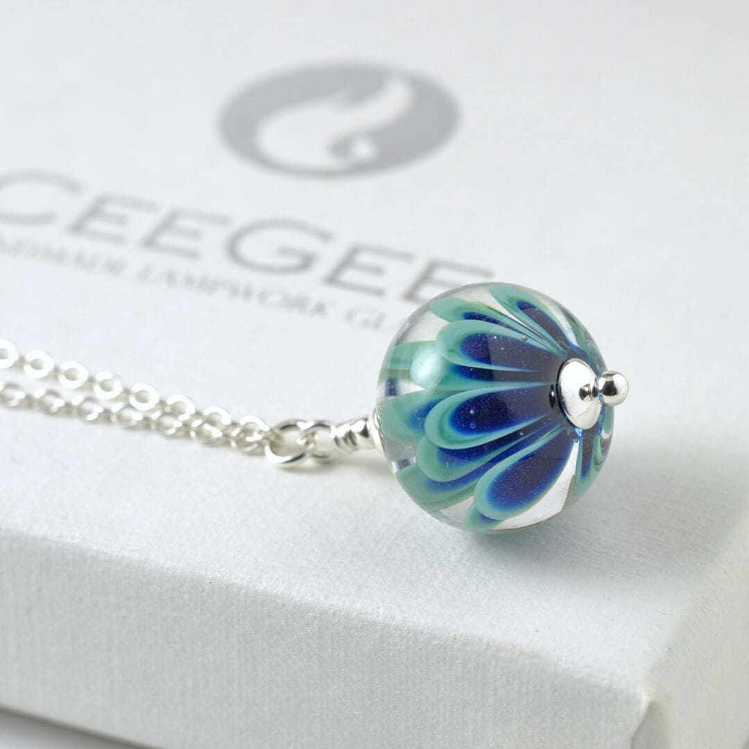 Lampwork glass floral pendant green blue on sterling silver chain