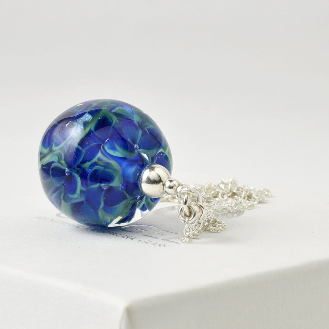 Deep blue green long lampwork glass floral pendant necklace