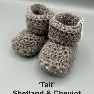 Pair of mid grey baby booties crocheted with a sheepskin sole in Shetland and Cheviot wool by Midge Porter Design