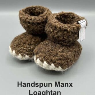 Pair of chocolate brown baby booties crocheted with a sheepskin sole in handspun Manx Loaghtan wool by Midge Porter Design