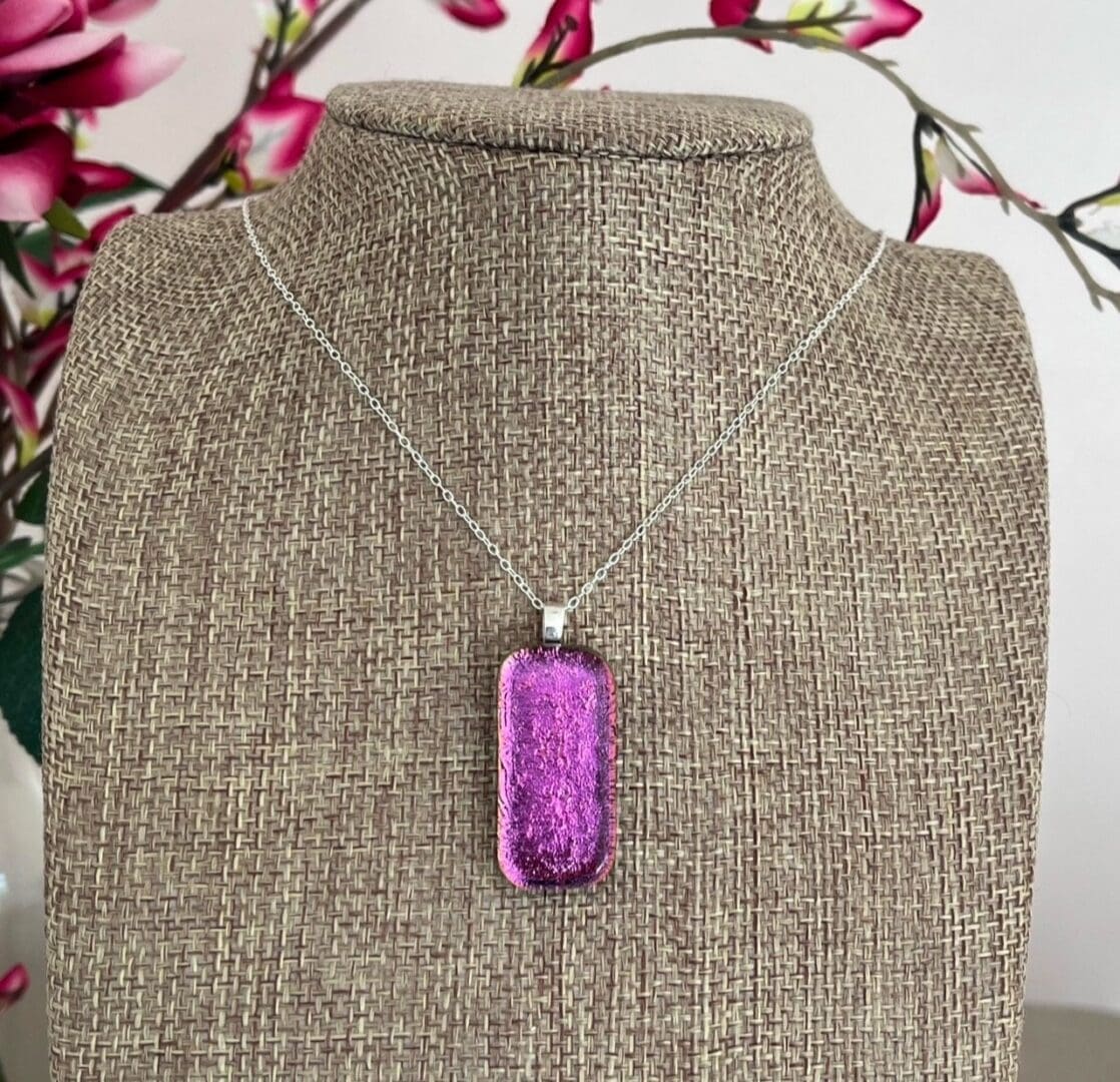 Bright pink sparkly dichroic glass pendant on a sterling silver chain