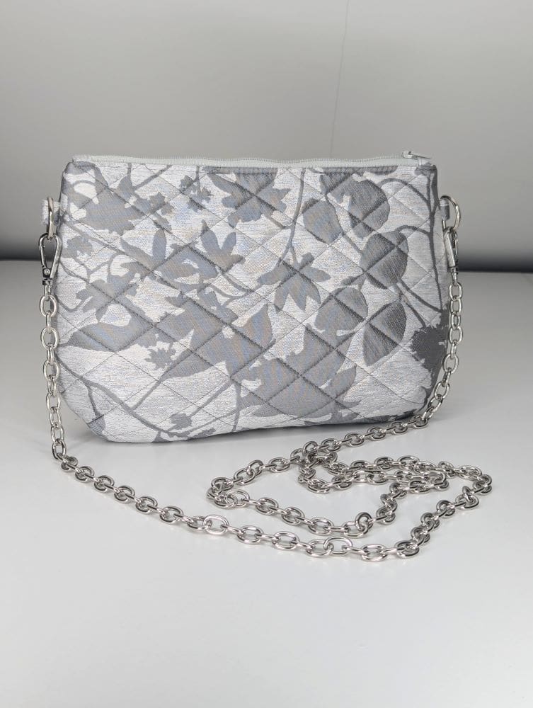 Chic silver handbag with a quilted texture and versatile chain strap