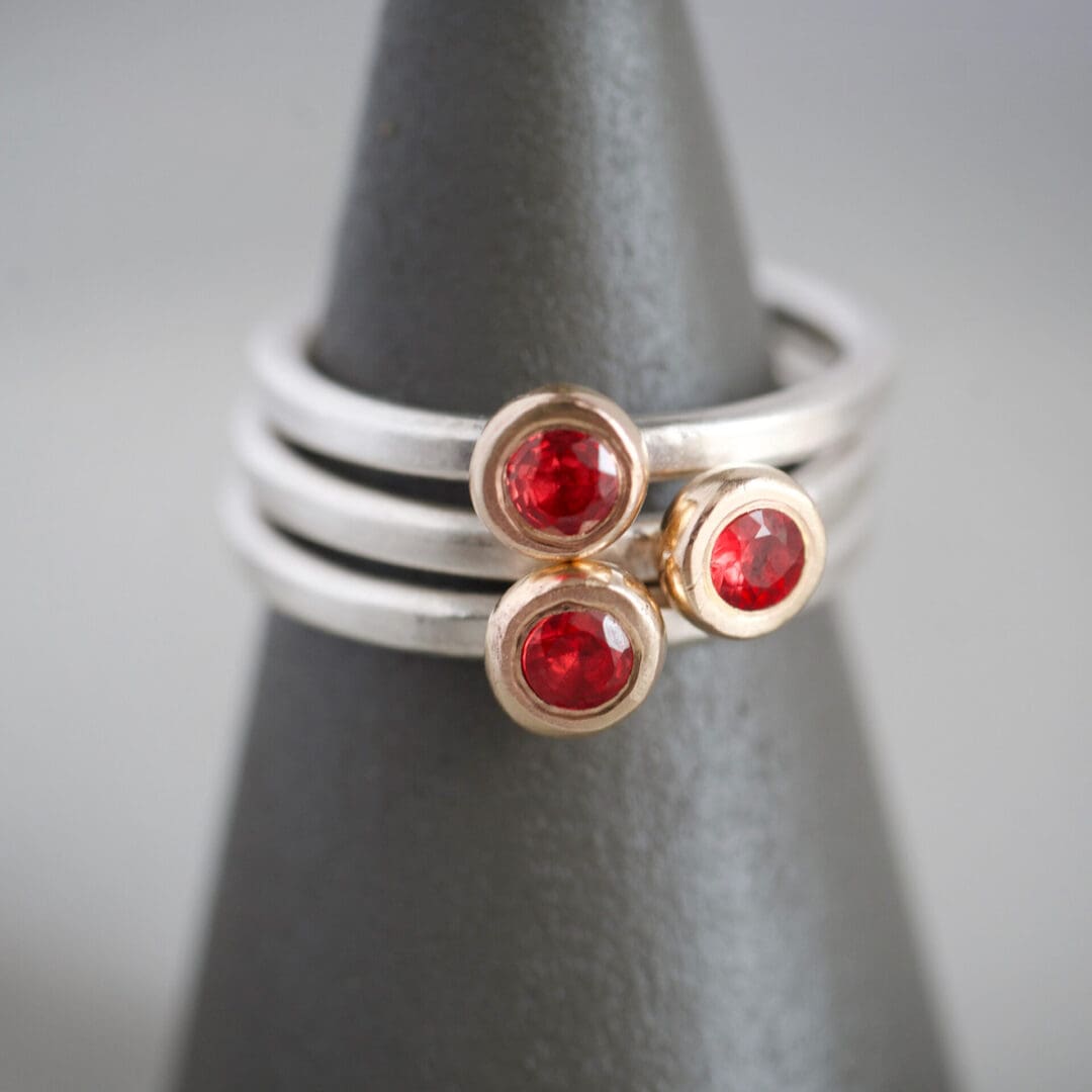 Red sapphire, 9ct yellow gold and sterling silver stacking ring set