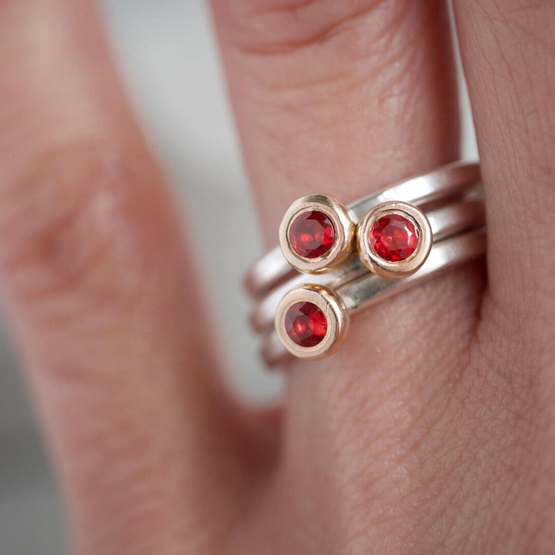 Red sapphire, 9ct yellow gold and sterling silver stacking ring set, worn