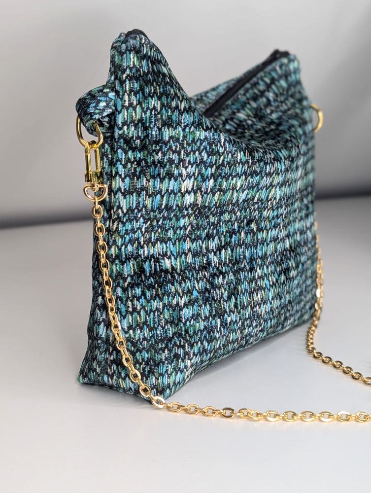 Stylish women's bag with a textured knitted design and gold-tone chain strap for a chic look