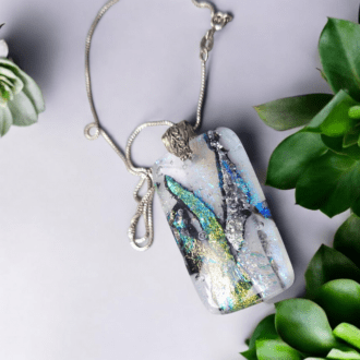 Handmade dichroic glass pendant with vibrant colours, decorative bail, and sterling silver chain, perfect as a bohemian statement necklace or gift for women on occasions like Christmas, Mother's Day, or anniversaries.