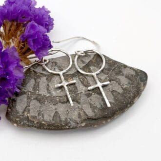 silver earrings in the shape of the female symbol of a circle with a cross below, on silver earwires all handmade