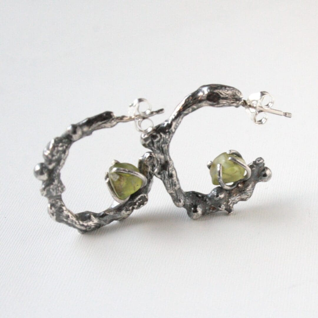 Silver twig hoop earrings with peridot gemstones