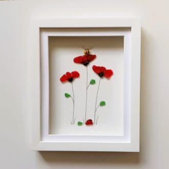 framed picture of three red poppies made with nuggets of Cornish sea glass