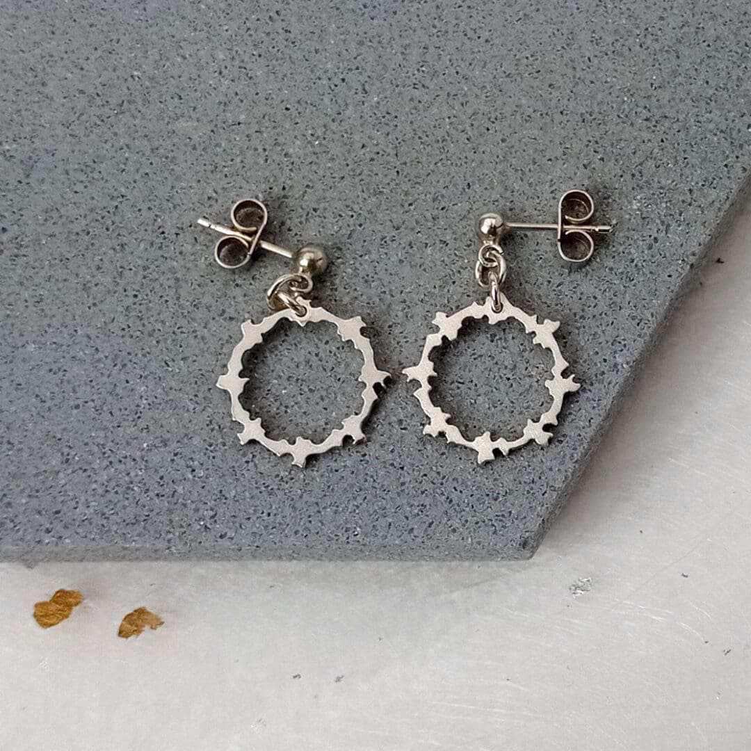 sterling silver round earrings with a pattern cut out