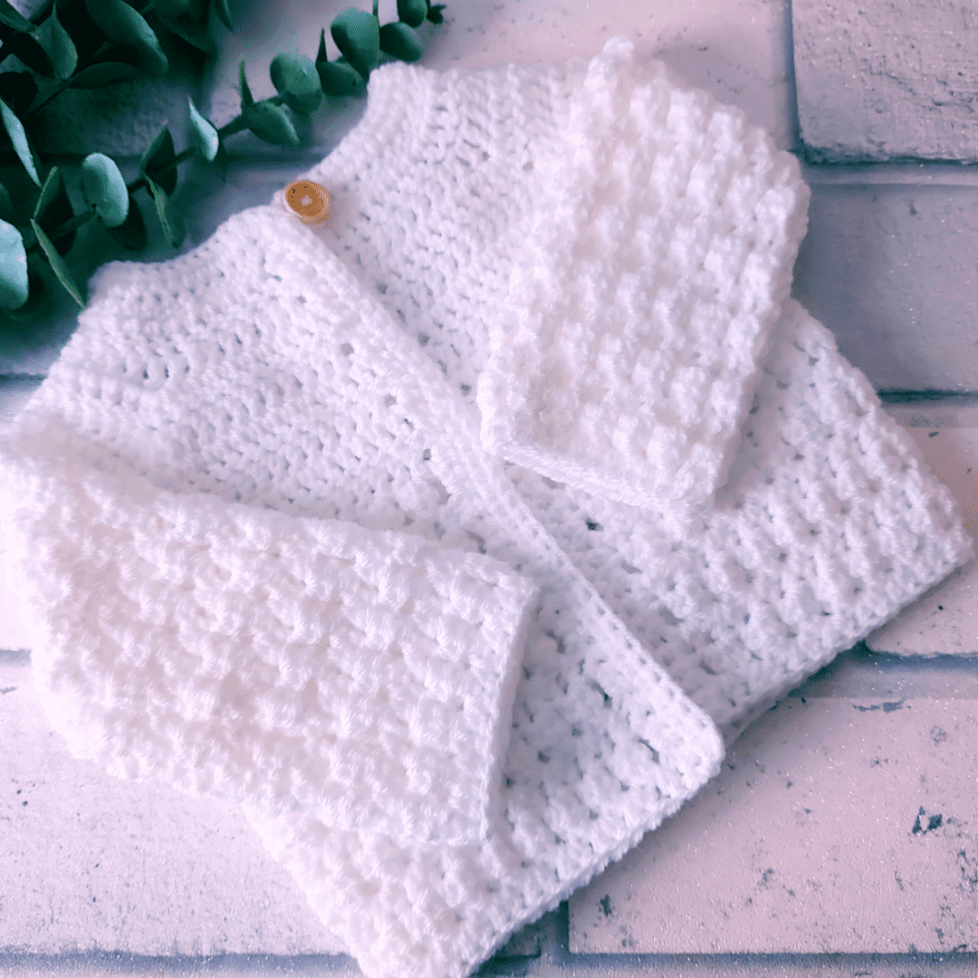 Handmade crochet baby cardigan made from soft yarn, perfect for newborns and toddlers. Ideal as a baby shower gift or keepsake, crafted with love in the UK Includeithd various colours and sizes available