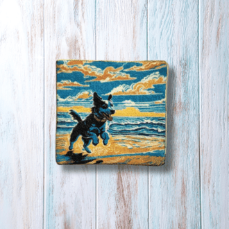 A square brooch with a happy dog on a beach.