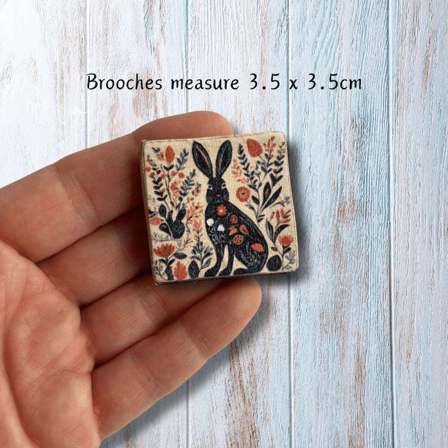 A square clay brooch with a hare print.