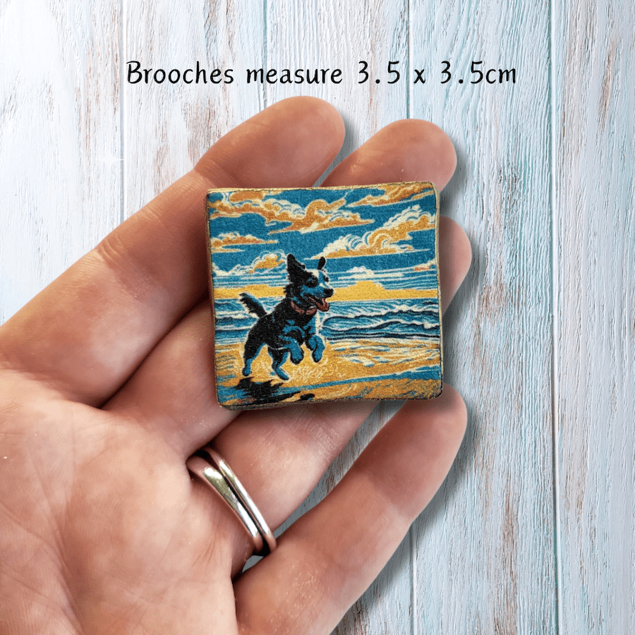 Handmade clay brooch with a dog on a beach print.