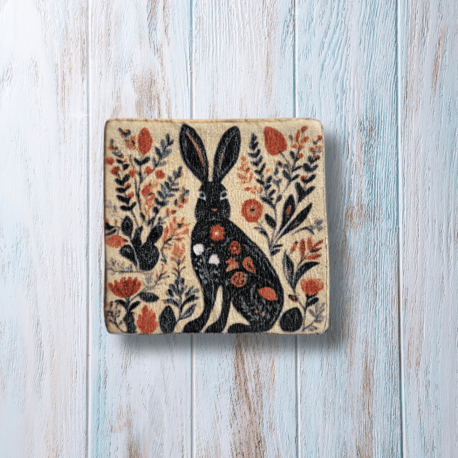 Square clay brooch with botanical hare print.