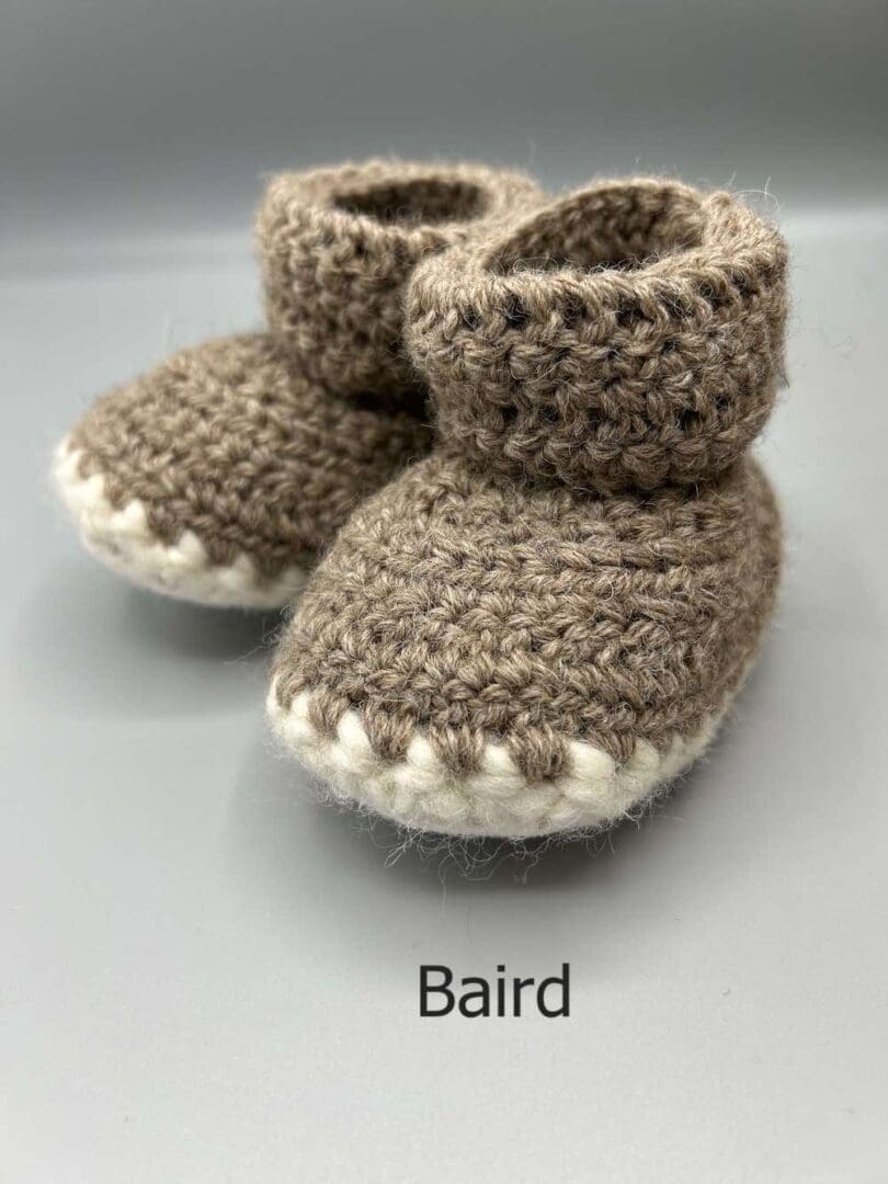 Pair of 100% Scottish Wool Baby soft shoes booties. Presented with a tartan ribbon and box. Handmade in Scotland by Midge Porter Design as part of the 'Peedie Naturals' Clan colours range - Baird