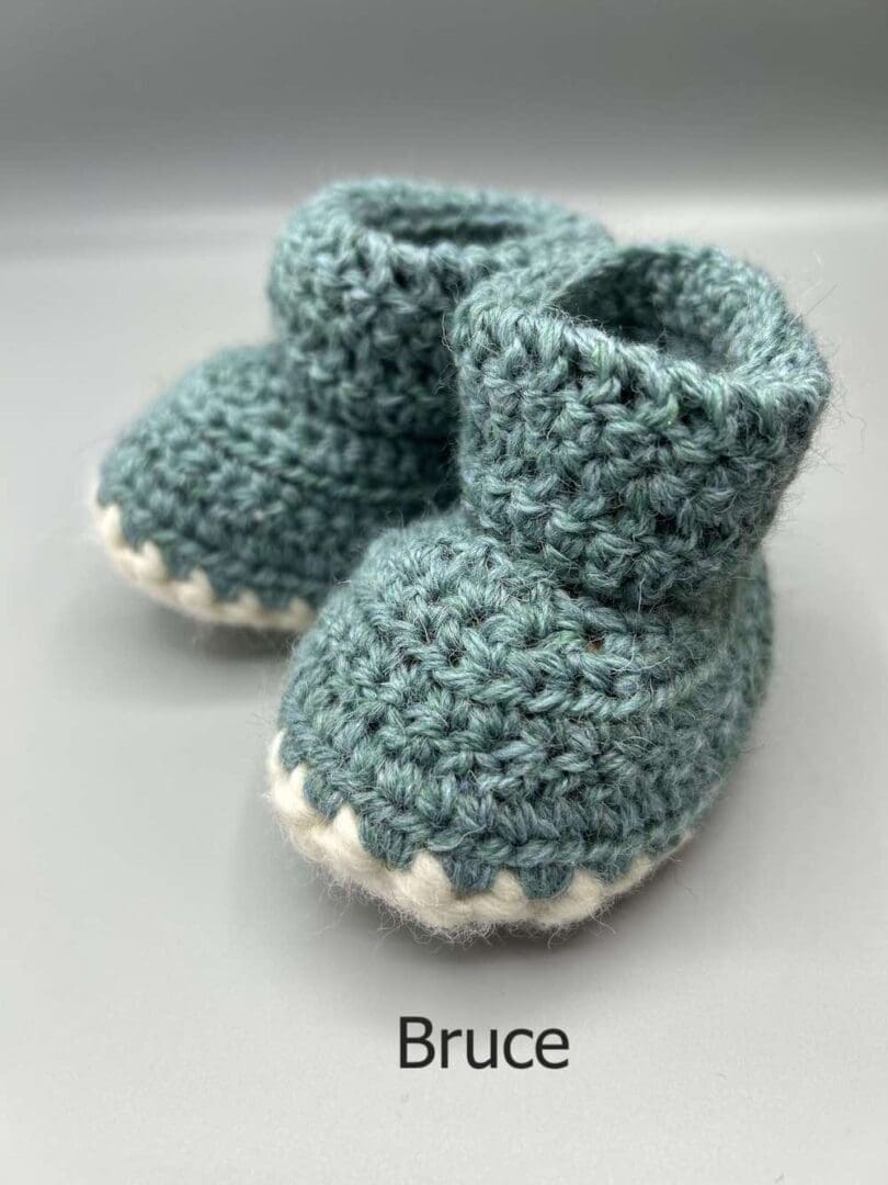 Pair of 100% Scottish Wool Baby soft shoes booties. Presented with a tartan ribbon and box. Handmade in Scotland by Midge Porter Design as part of the 'Peedie Naturals' Clan colours range - Bruce