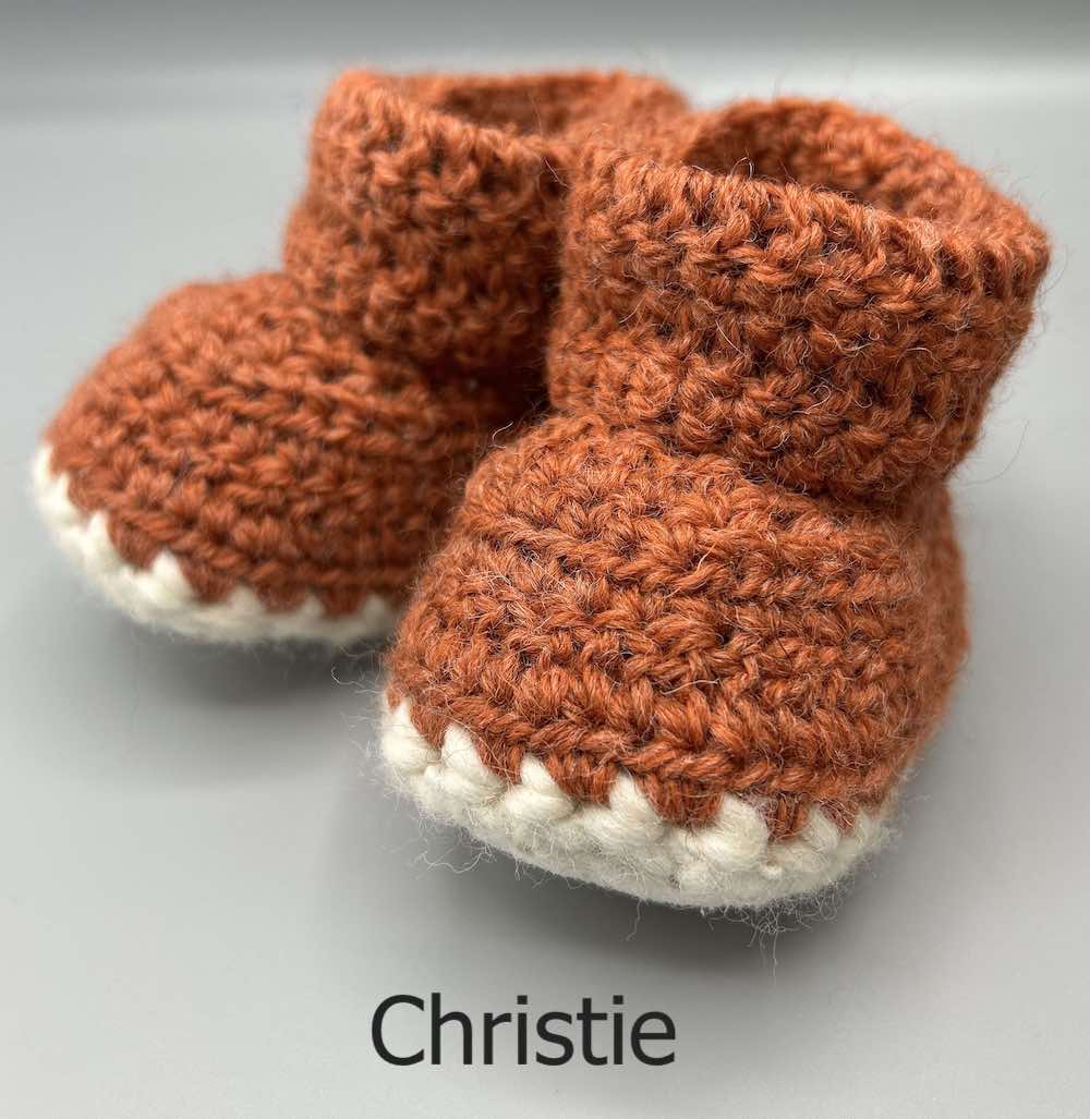 Pair of 100% Scottish Wool Baby soft shoes booties. Presented with a tartan ribbon and box. Handmade in Scotland by Midge Porter Design as part of the 'Peedie Naturals' Clan colours range - Christie