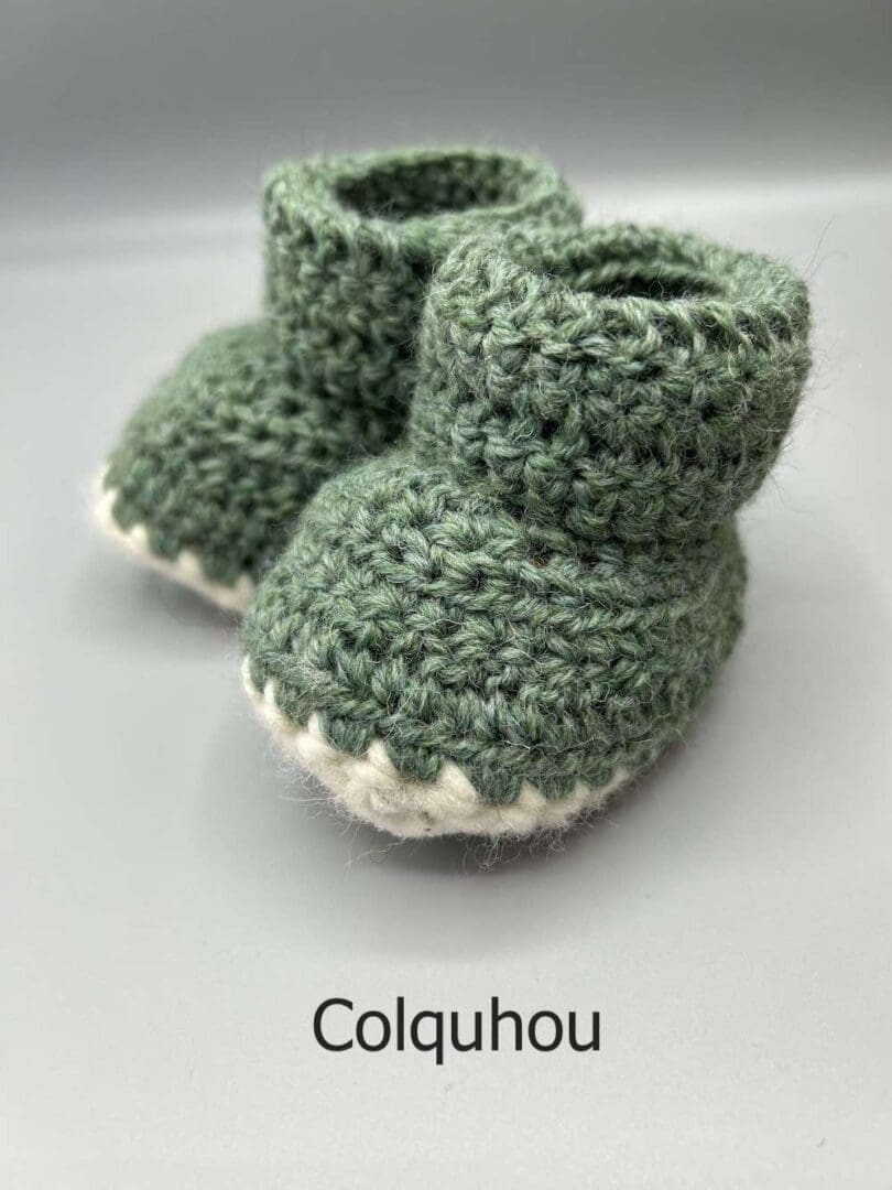 Pair of 100% Scottish Wool Baby soft shoes booties. Presented with a tartan ribbon and box. Handmade in Scotland by Midge Porter Design as part of the 'Peedie Naturals' Clan colours range - Colquhoun