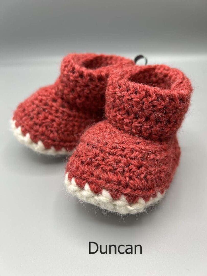 Pair of 100% Scottish Wool Baby soft shoes booties. Presented with a tartan ribbon and box. Handmade in Scotland by Midge Porter Design as part of the 'Peedie Naturals' Clan colours range - Duncan