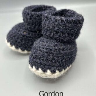 Pair of 100% Scottish Wool Baby soft shoes booties. Presented with a tartan ribbon and box. Handmade in Scotland by Midge Porter Design as part of the 'Peedie Naturals' Clan colours range - Gordon