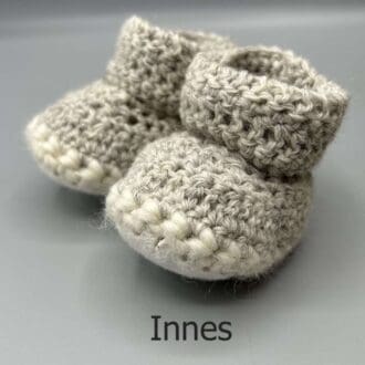 Pair of 100% Scottish Wool Baby soft shoes booties. Presented with a tartan ribbon and box. Handmade in Scotland by Midge Porter Design as part of the 'Peedie Naturals' Clan colours range - Innes