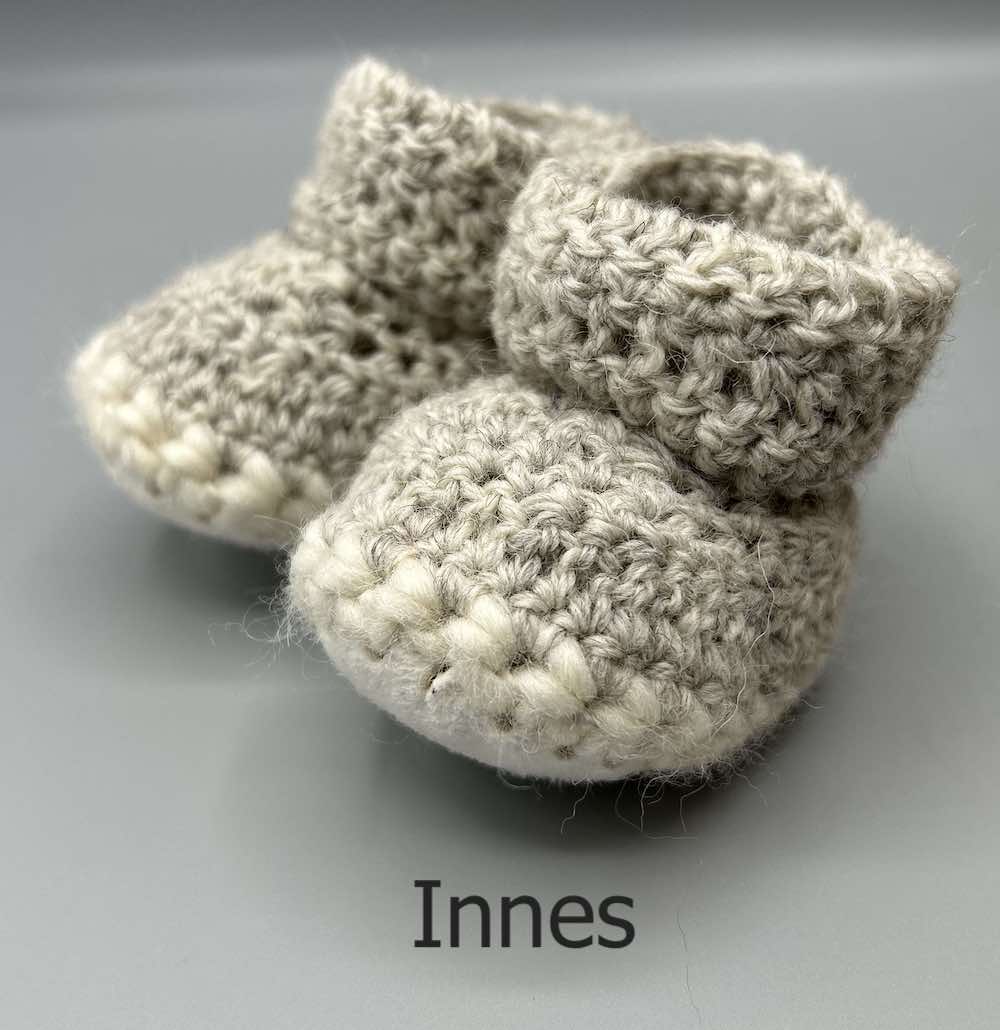 Pair of 100% Scottish Wool Baby soft shoes booties. Presented with a tartan ribbon and box. Handmade in Scotland by Midge Porter Design as part of the 'Peedie Naturals' Clan colours range - Innes