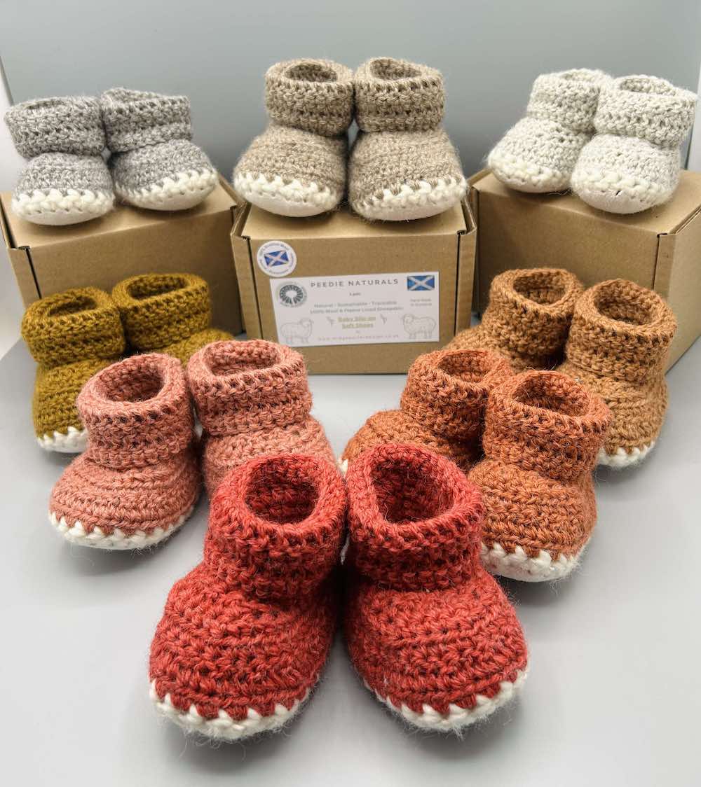 Pair of 100% Scottish Wool Baby soft shoes booties. Presented with a tartan ribbon and box. Handmade in Scotland by Midge Porter Design as part of the 'Peedie Naturals' Clan colours range.