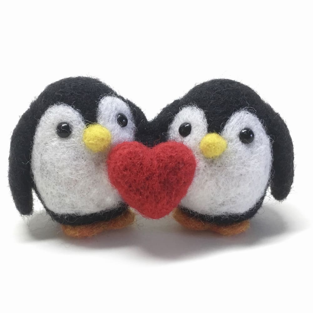 Handcrafted needle-felted penguin couple holding a red heart, perfect for Valentine’s Day or romantic gifts.