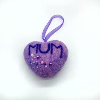 Purple needle-felted heart ornament with 'MUM' in dark blue lettering and decorative beads, perfect for Mother’s Day gifts